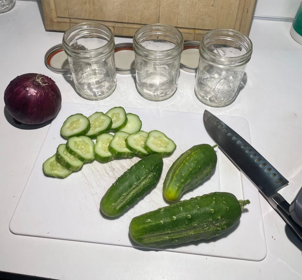 fresh-sliced-cucumber Fresh cucumber sliced, along with more fresh cucumbers and an onion.